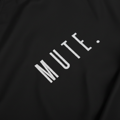 M U T E . Diagonal Lapel Technical Jacket - lapel branding detail
